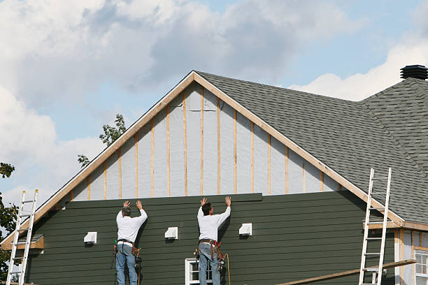 Professional Storm Damage Siding Repair technician working in Amherst, OH